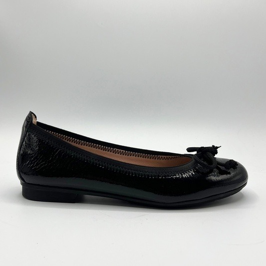 Black flat shoe with a bow on a white background