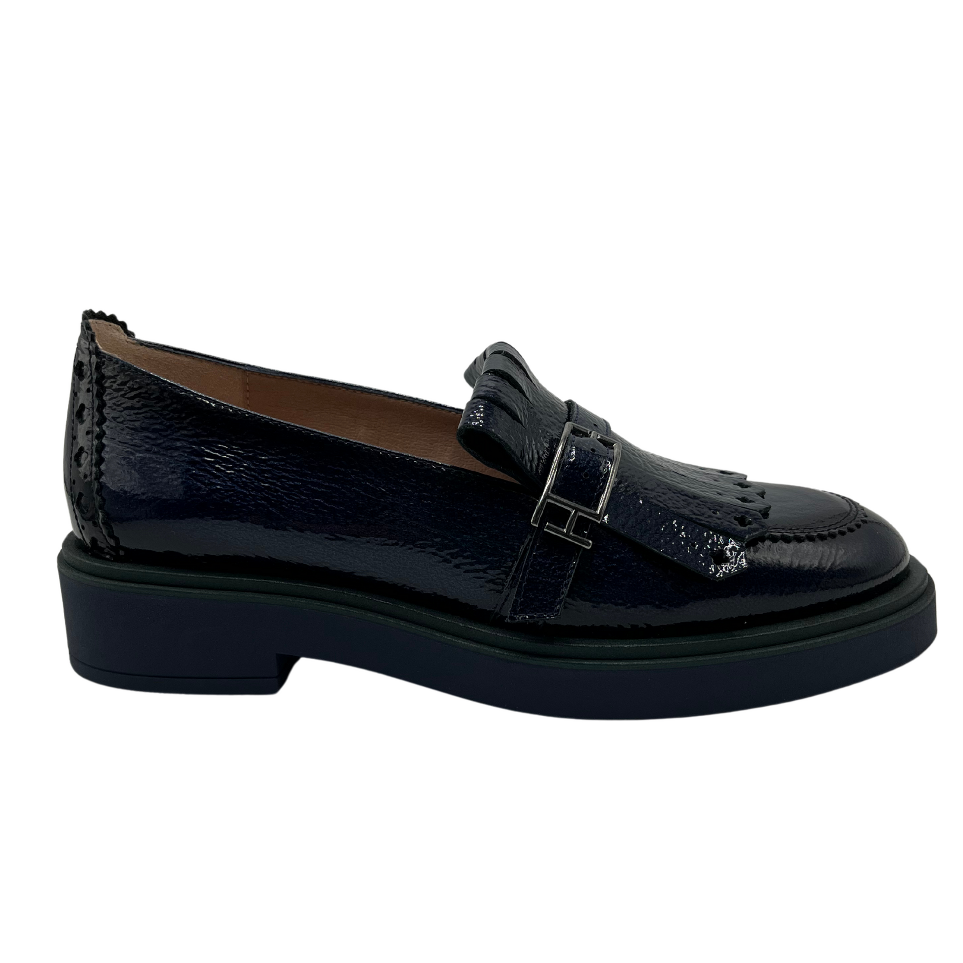 Right facing view of midnight blue leather loafer with low heel and adjustable buckle on upper.
