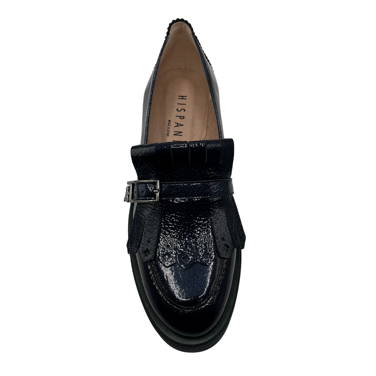 Top view of midnight blue leather loafer with low heel and adjustable buckle on upper.