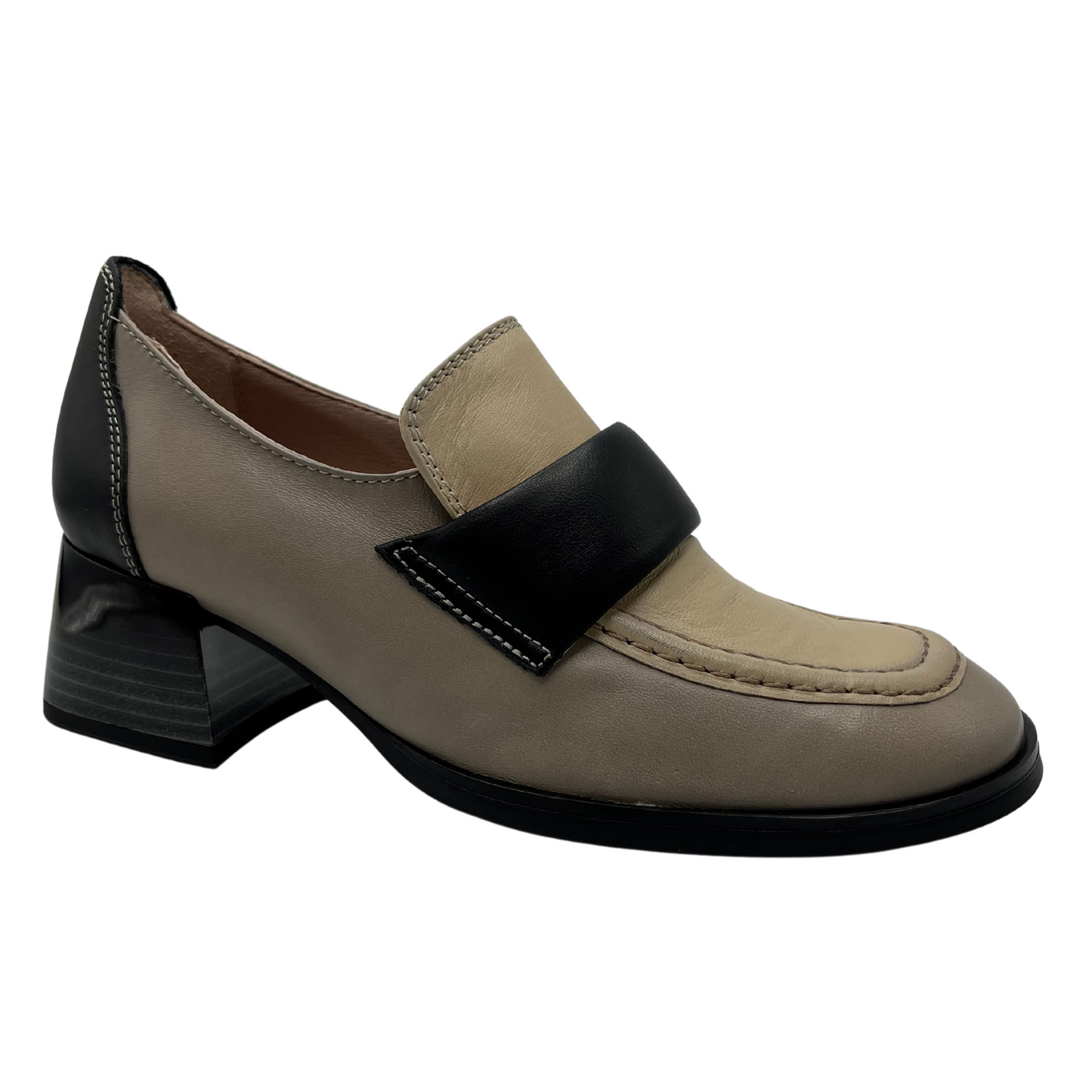 45 degree angled view of beige and black leather loafer with block stacked heel and rounded toe