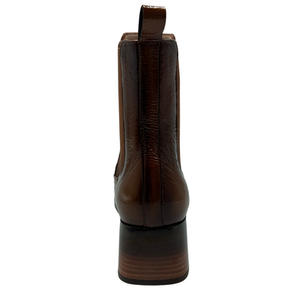 Back view of brown leather short boot with block heel and pull on tab