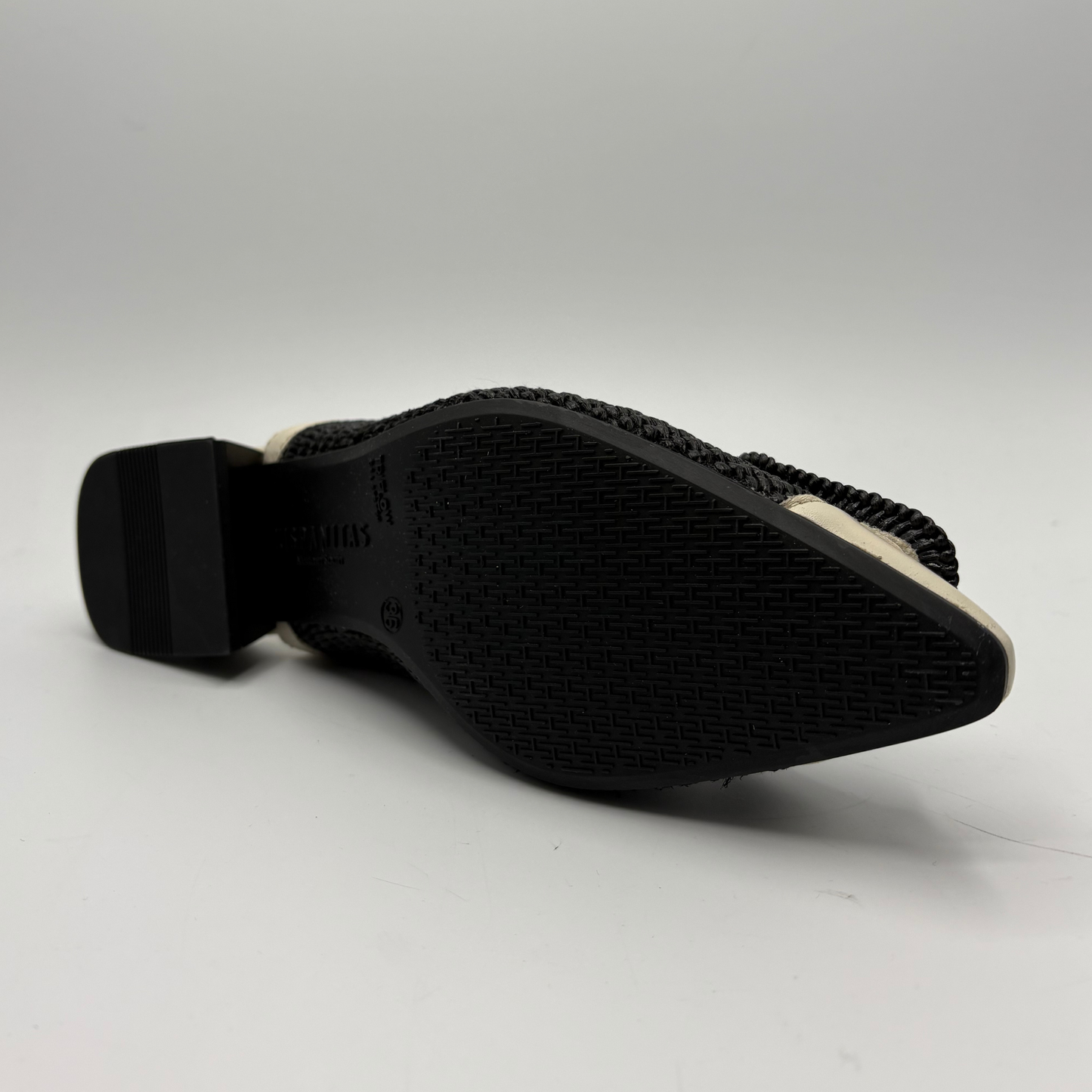 Black shoe sole with textured pattern on a white background