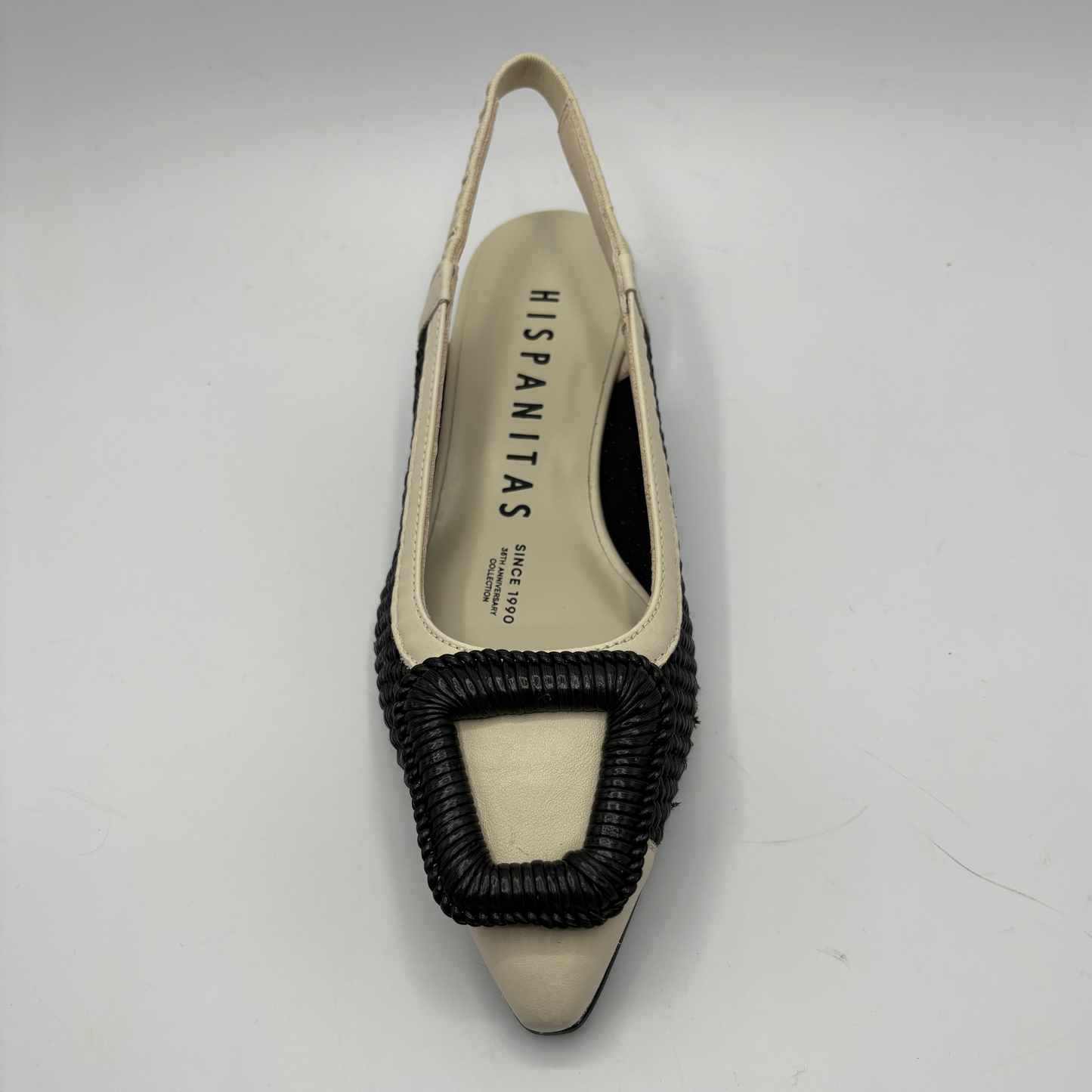 Black and beige shoe with 'Hispanitas' branding on a gray background