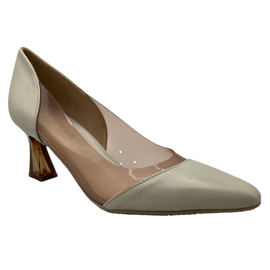45 degree angled view of white and nude pump with pointed toe and flared heel