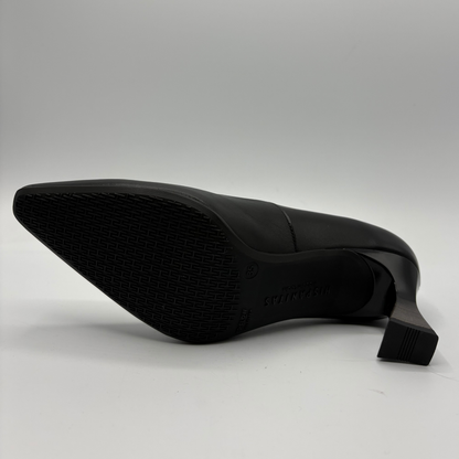 A black pointed-toe high heel shoe shown from a side angle, displaying its textured rubber outsole and block heel on a light gray background.