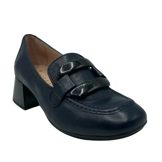 45 degree angled view of navy leather loafer with chunky buckle detail and block heel