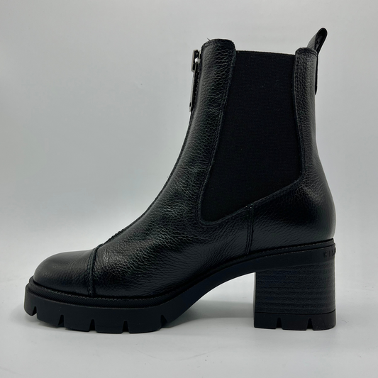 Black leather boot with a block heel on a gray background