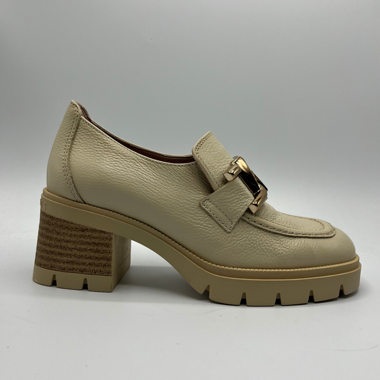 Beige leather shoe with a gold buckle on a gray background