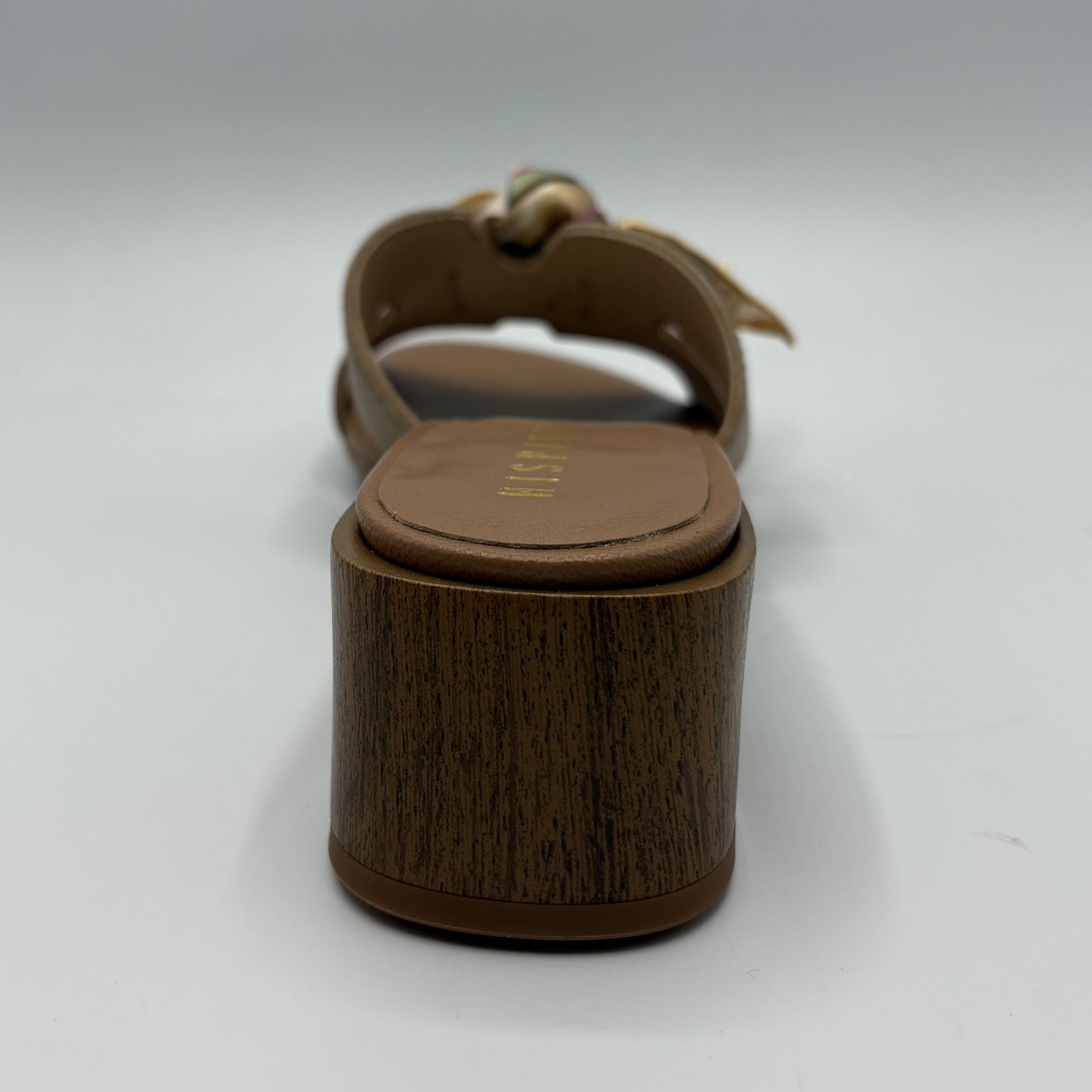 Brown sandal with wooden sole on a white background