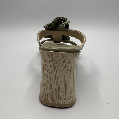 Green sandal with ruffled design on a white background
