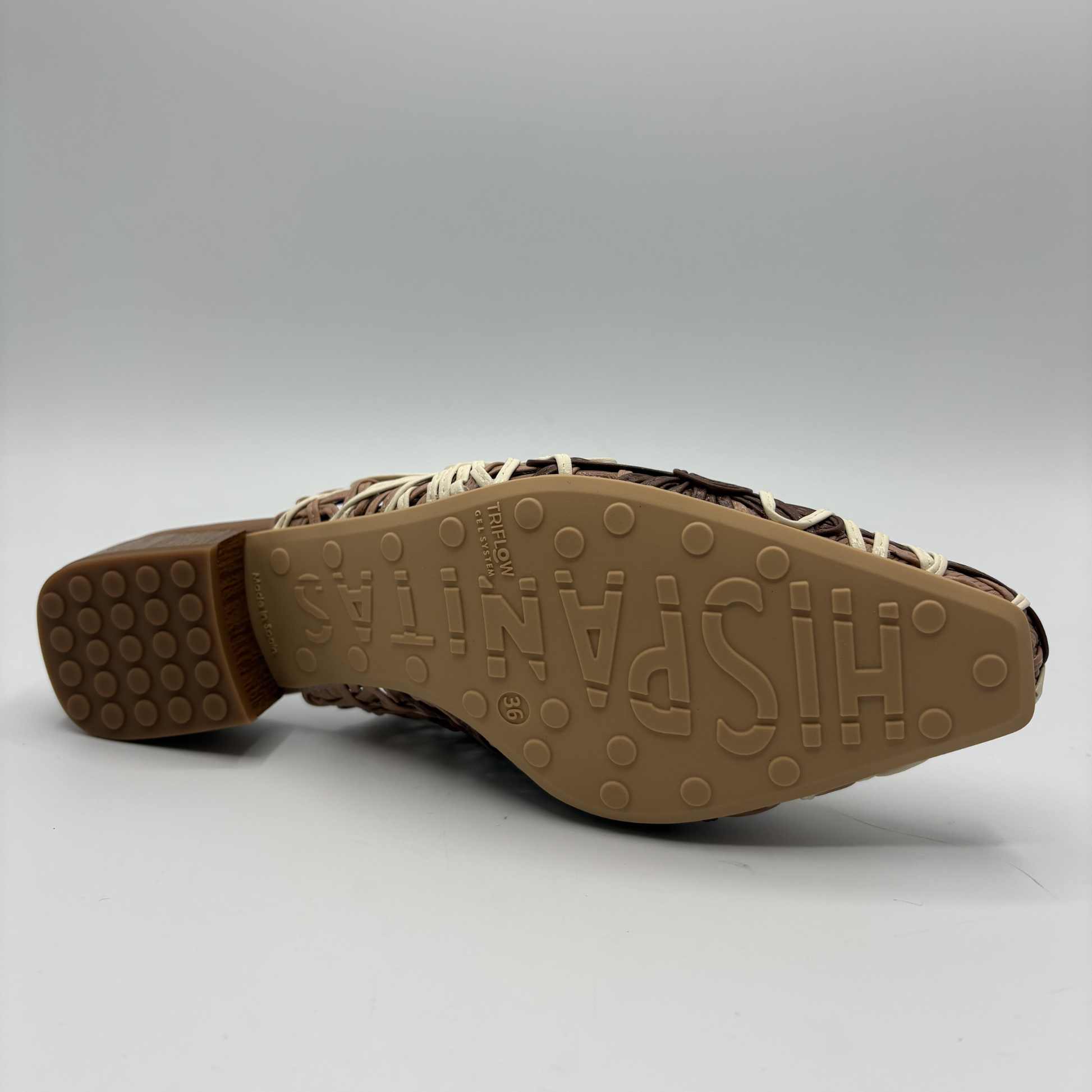Close-up of a shoe sole with 'Hispanitas’ branding on a gray background