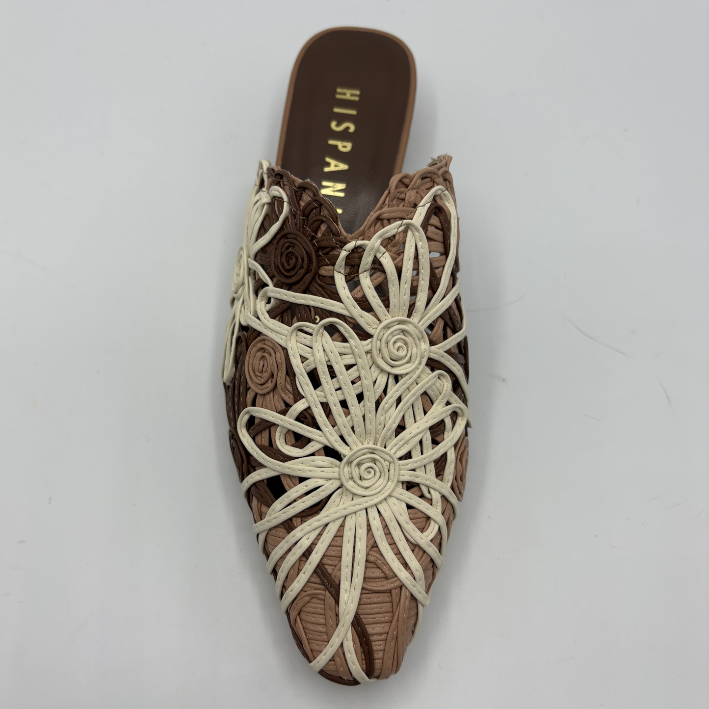 Brown shoe with floral patterns on a gray background