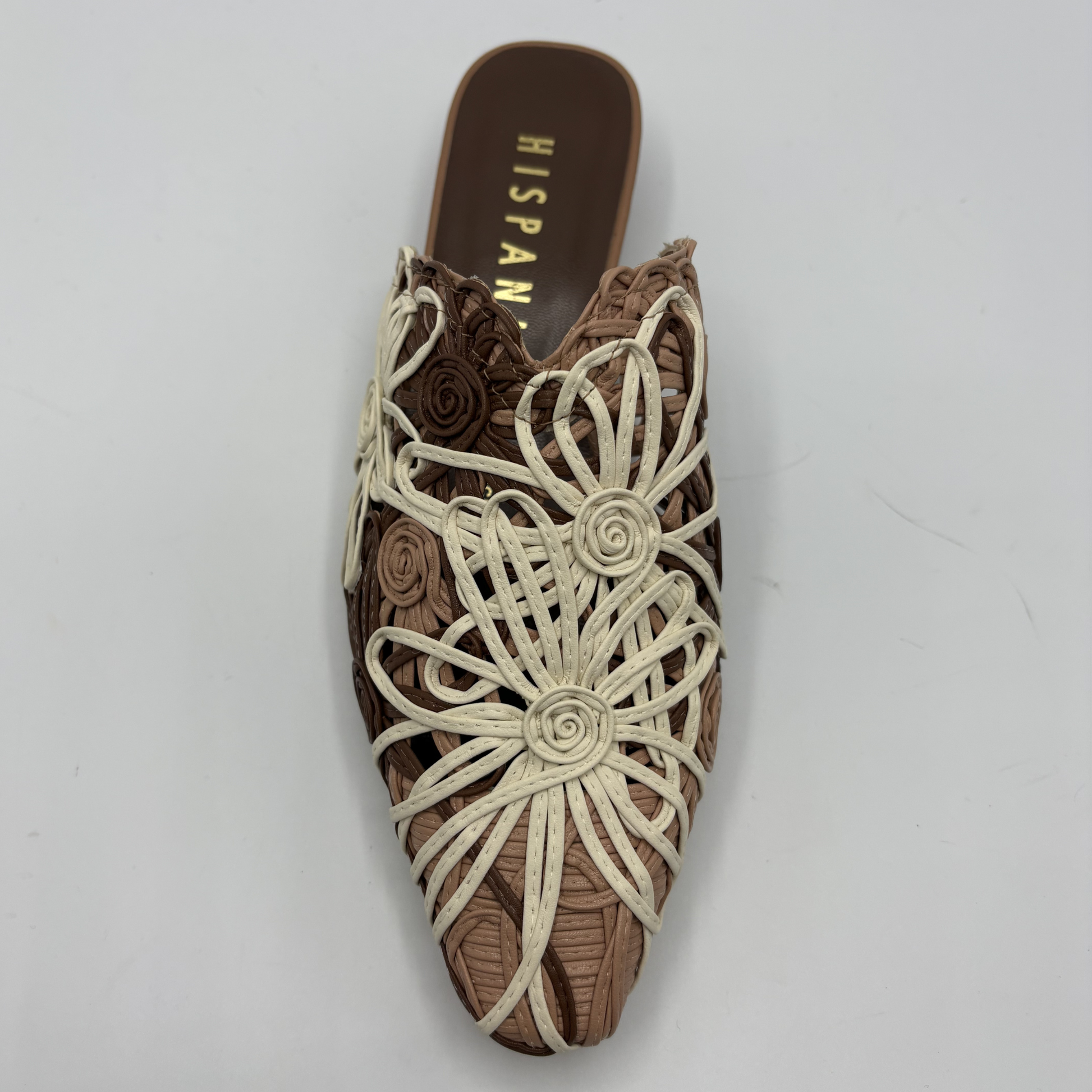 Brown shoe with floral patterns on a gray background