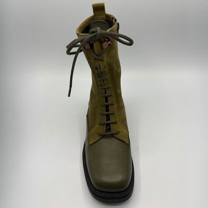 Top view of an army green lace up boot with a black rubber outsole