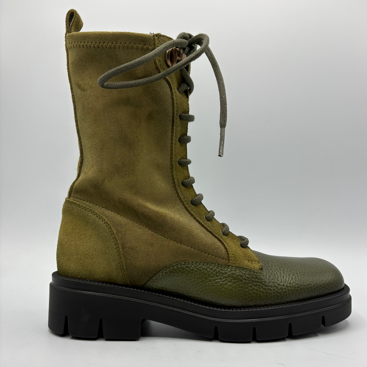 Right facing view of an army green lace up boot with a black rubber outsole