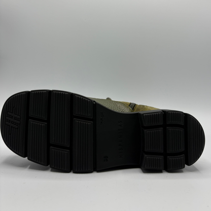 Bottom view of an army green lace up boot with a black rubber outsole
