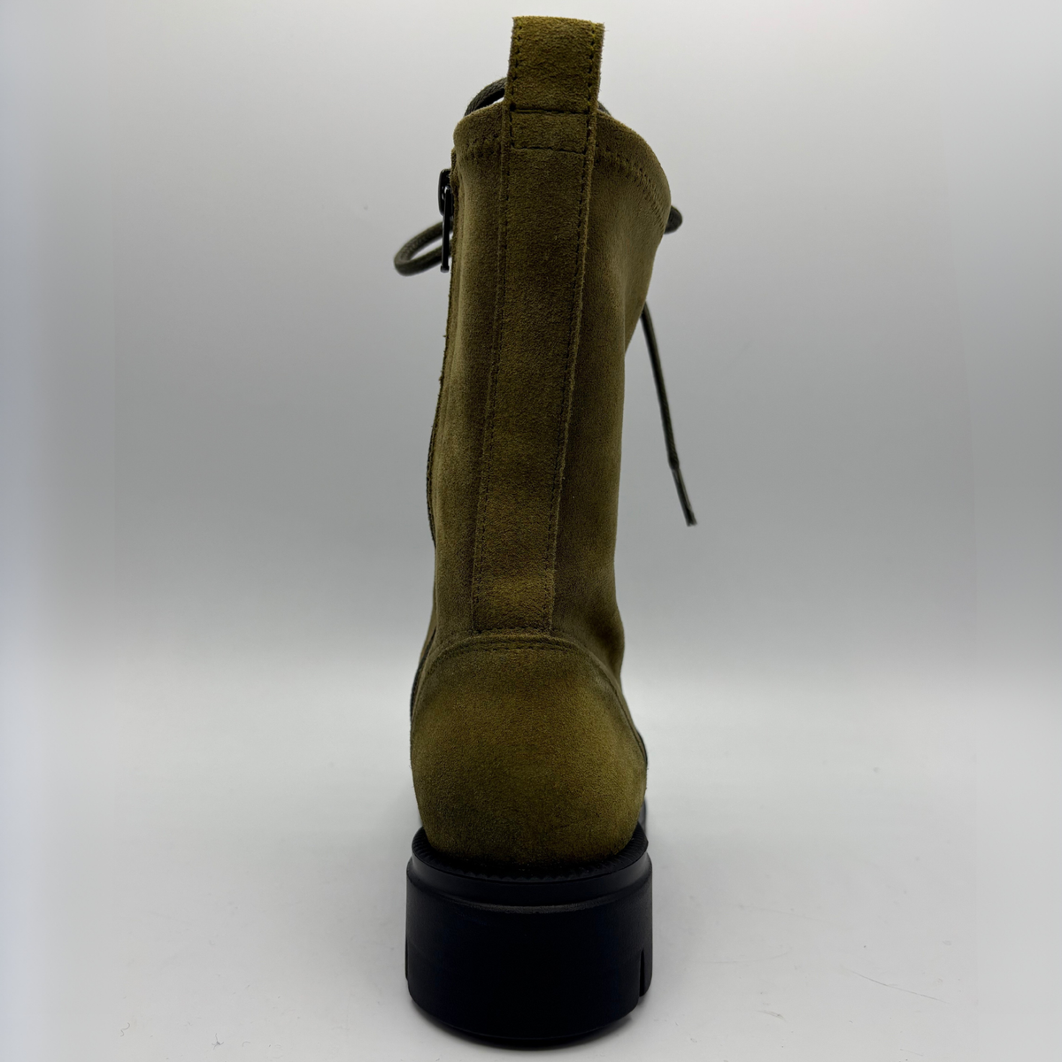 Back view of an army green lace up boot with a black rubber outsole