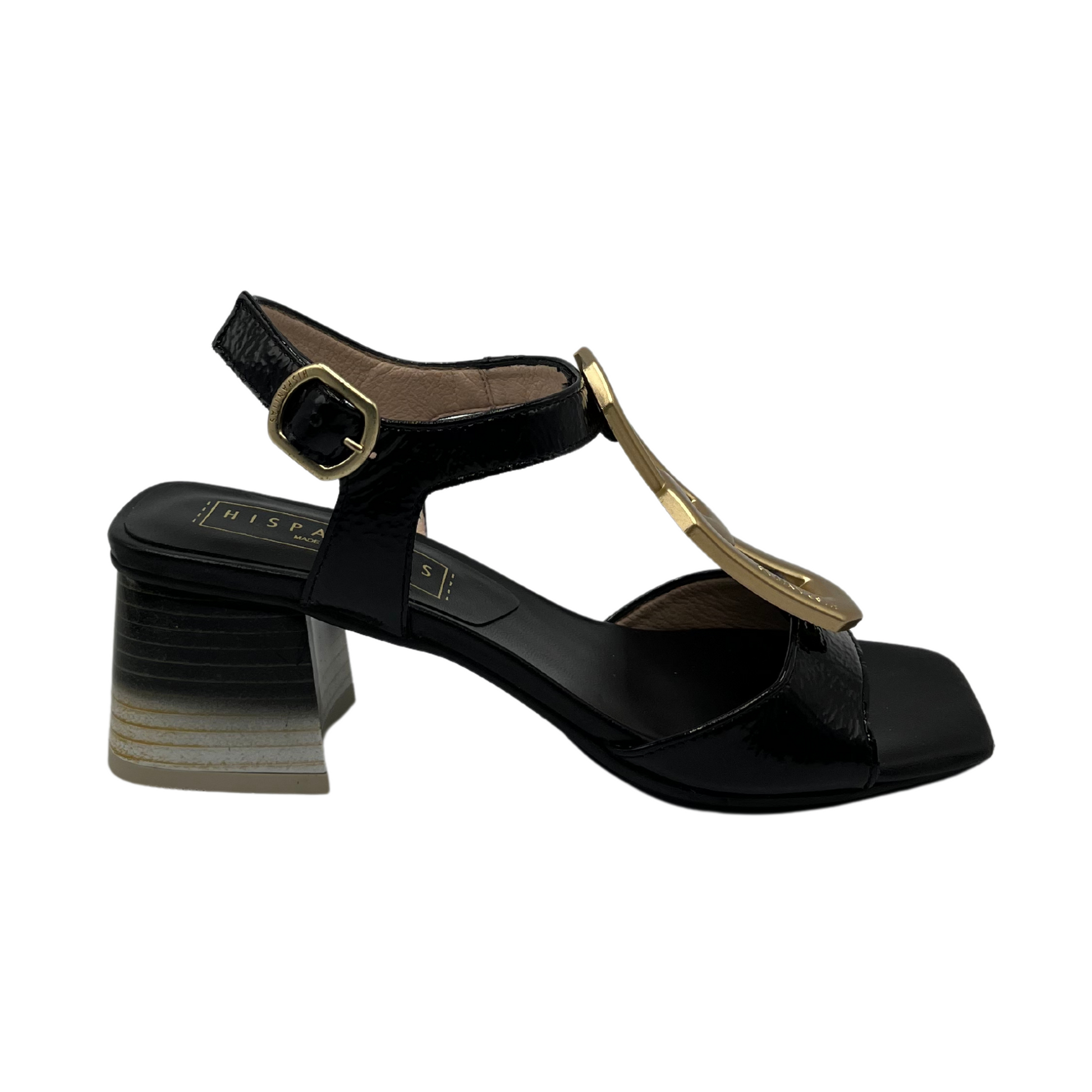 Right facing view of black patent leather sandals with adjustable strap, ombre heel and gold brooch detail on upper