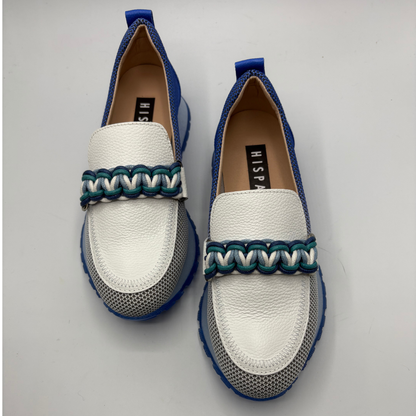 White loafers with blue and green accents on a light gray background