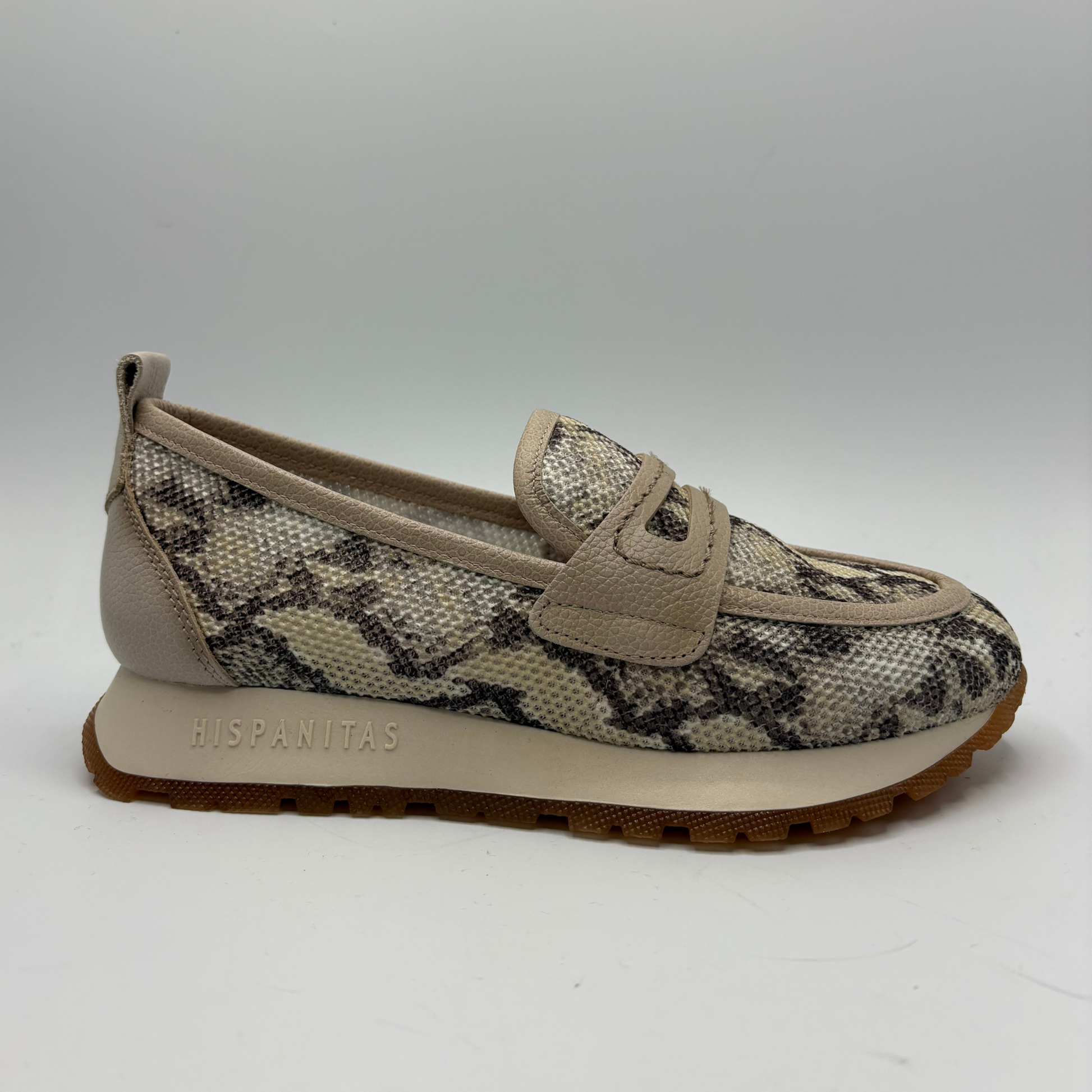 Beige slip-on shoe with snake print pattern on a white background