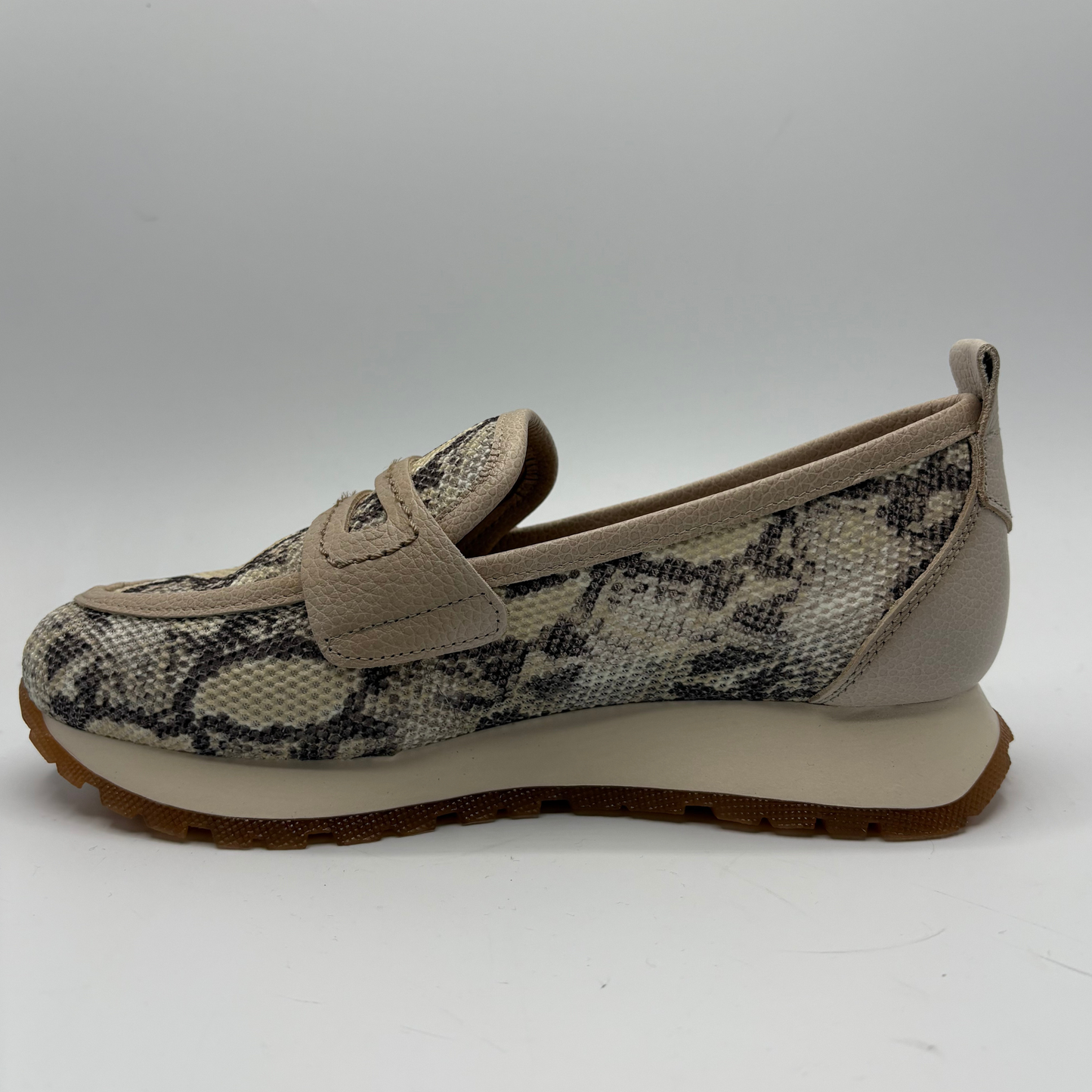 Loafer shoe with snake print pattern on a white background