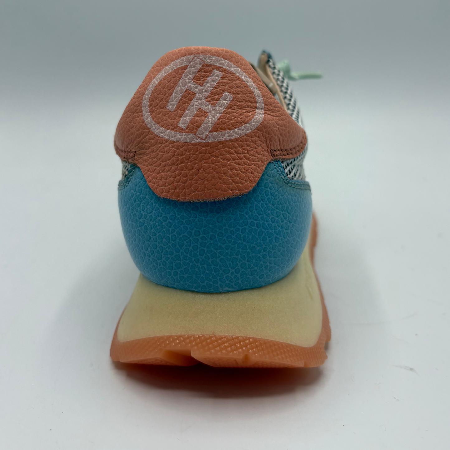 Close-up of a shoe with a brand logo on a white background