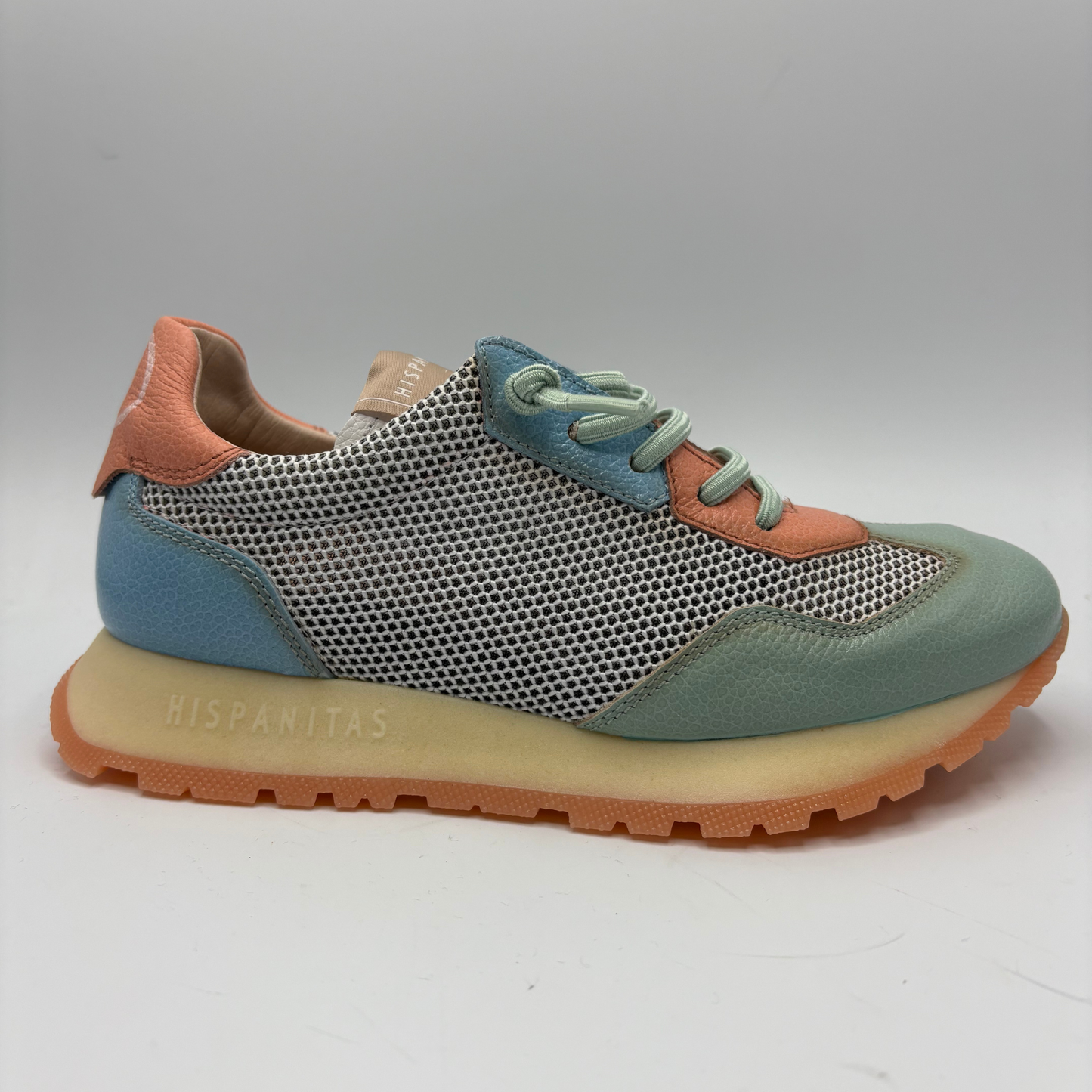 Multicolored sneaker with a textured sole on a white background