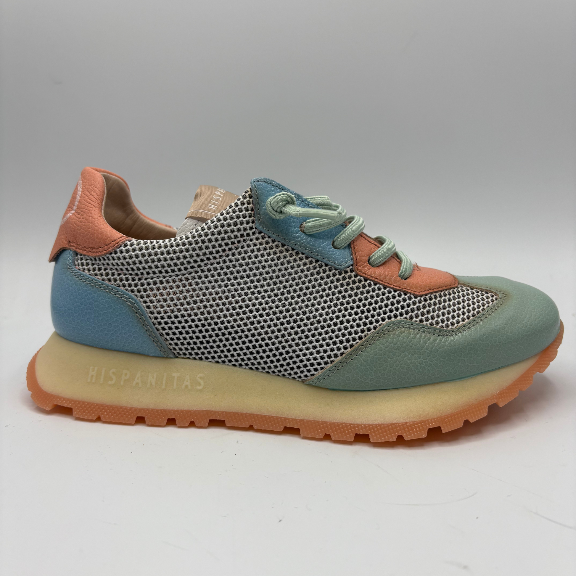 Multicolored sneaker with a textured sole on a white background