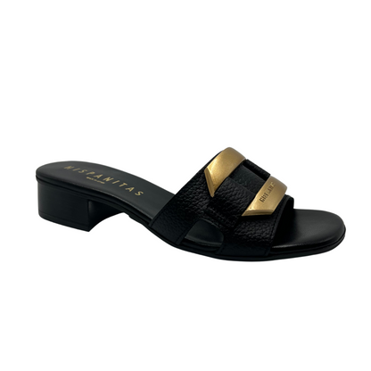 45 degree angled view of black mule sandal with gold brooch detail on upper