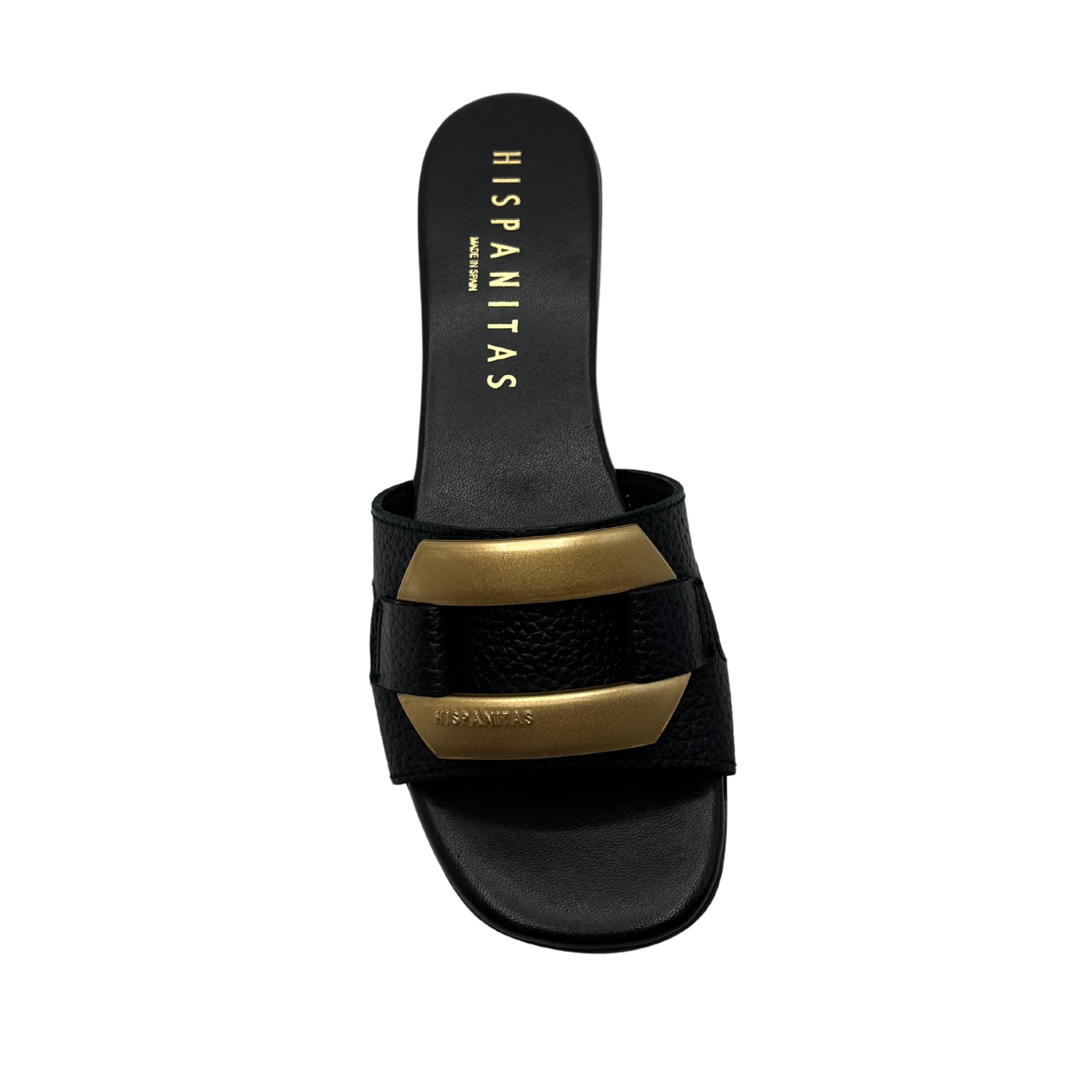 Top view of black mule sandal with gold brooch detail on upper