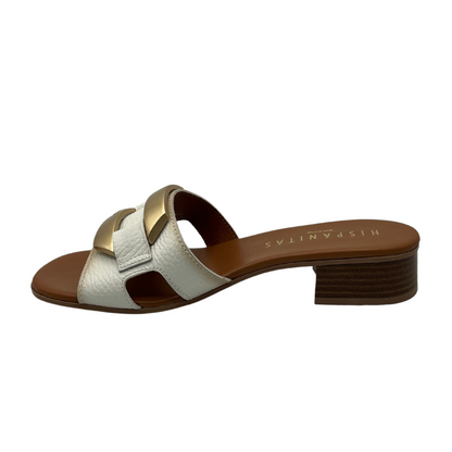 Left facing view of white leather sandal with brown insole and 3cm heel with gold brooch detail on upper