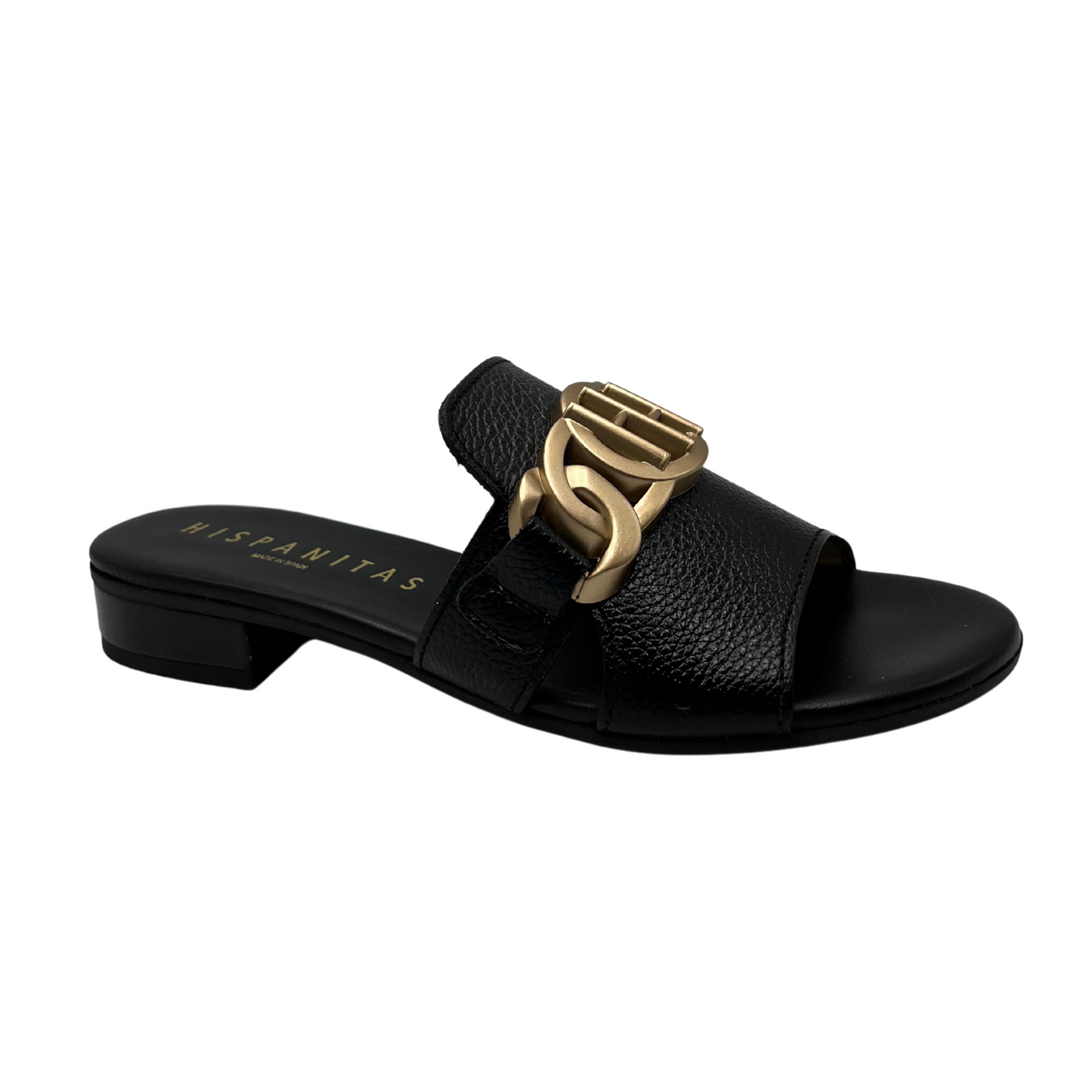 Angled view of black leather slip on sandal with a low block heel and gold detail on upper.