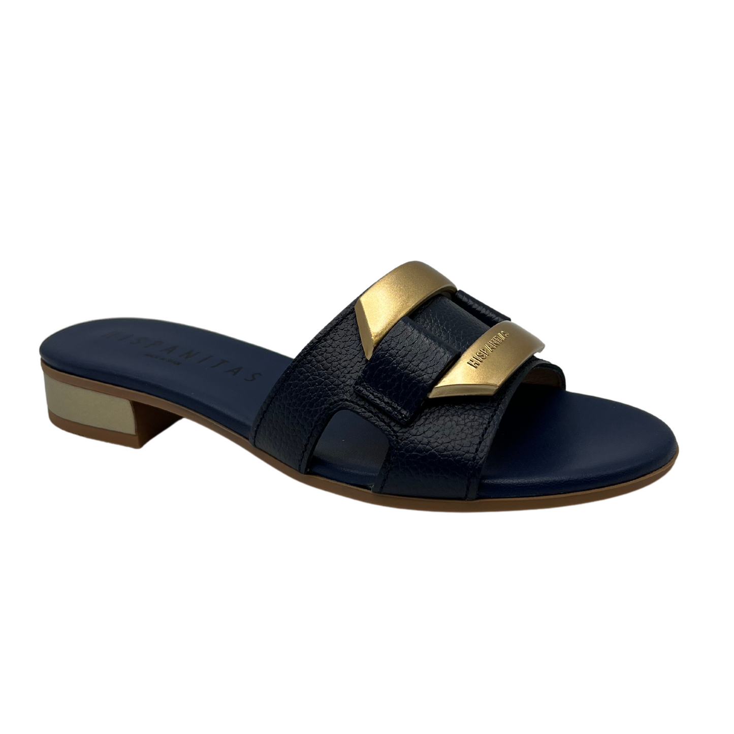 Angled view of slip on sandal with a navy coloured leather strap. Leather lined, short block heel and gold detail on upper.