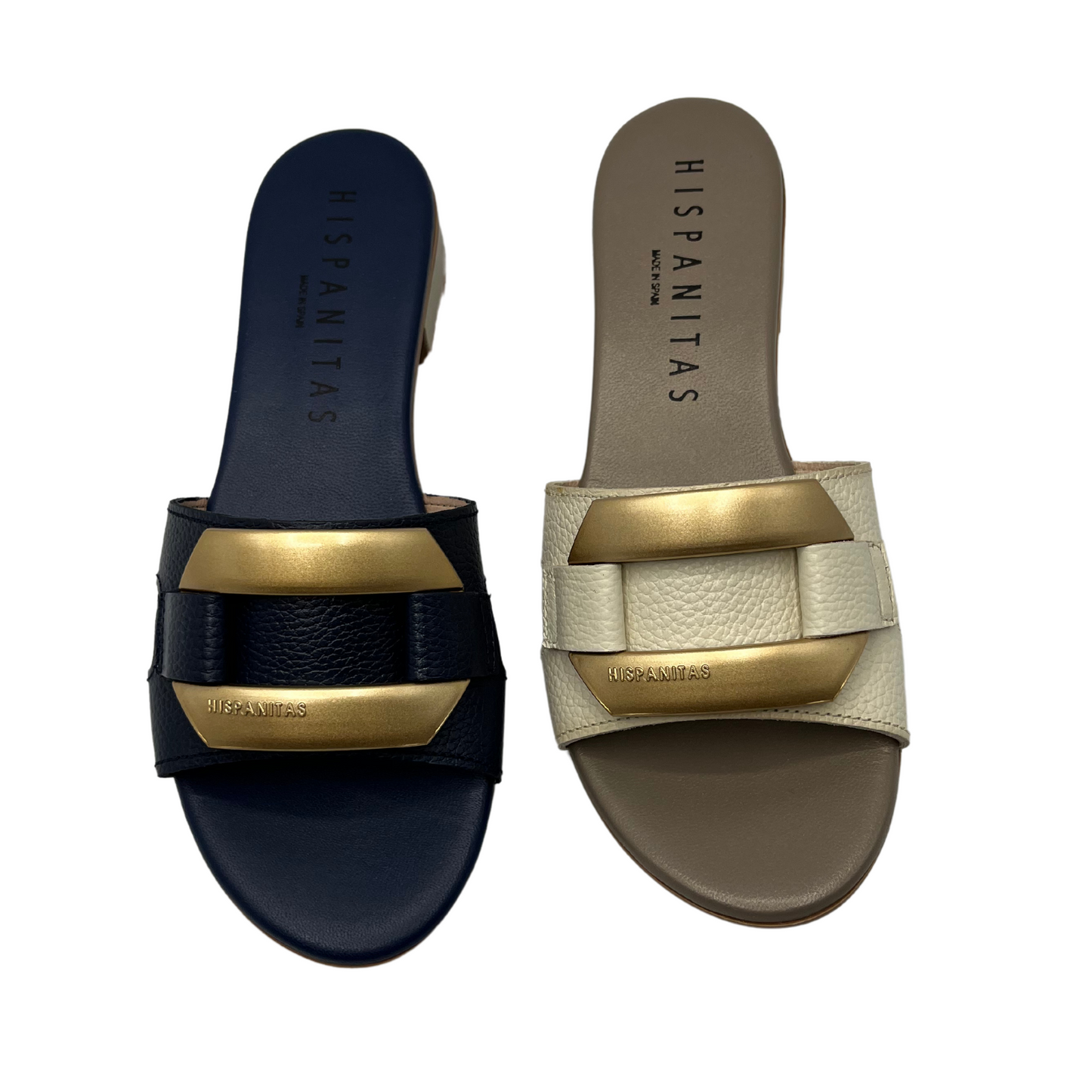 Top view of a pair of slip on leather sandals. One is navy and the other is cream coloured. Both have a gold detail on upper and are leather lined.