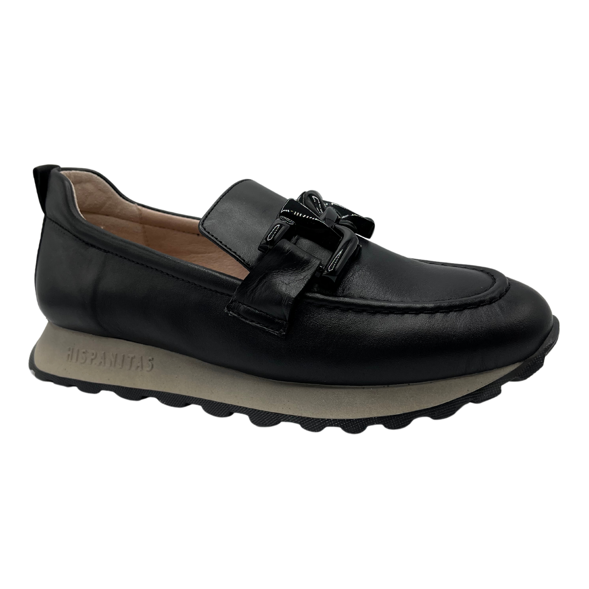 45 degree angled view of black leather loafer with chunky treaded sole and leather lining