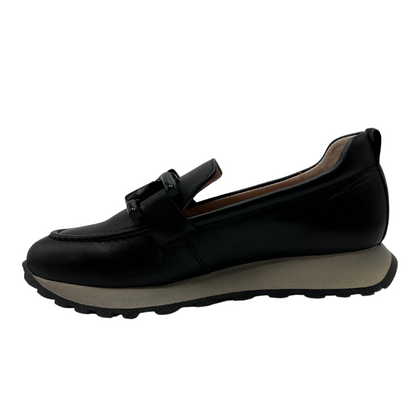 Left facing view of black leather loafer with chunky treaded sole and leather lining