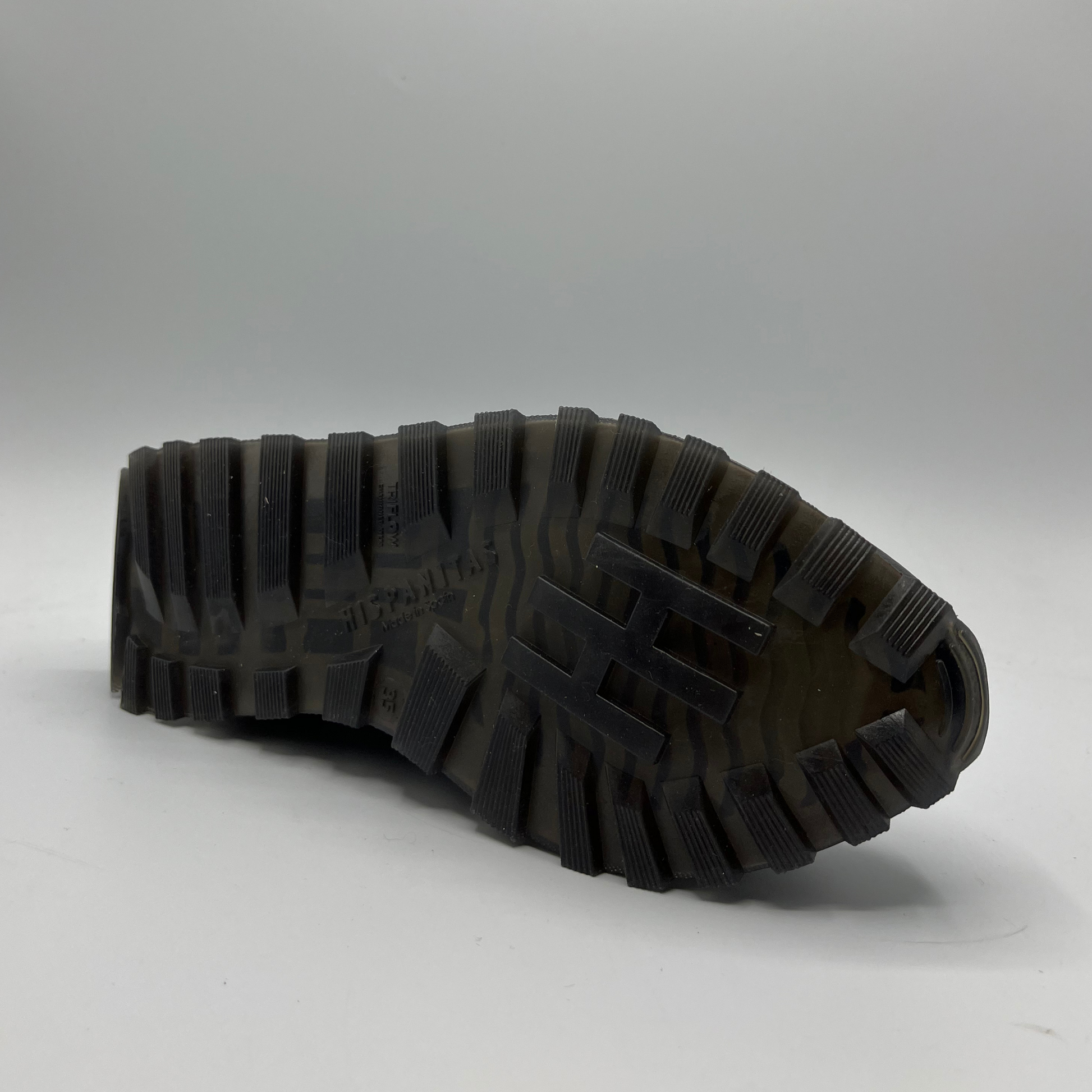 Close-up of a black rubber sole on a white background