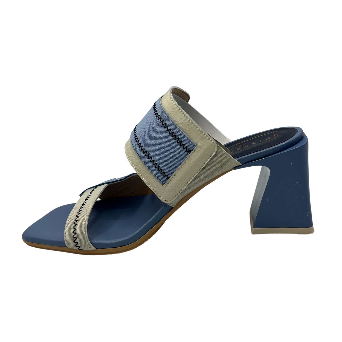 Left facing view of blue and natural leather and elastic slip on sandal. Featuring a square toe and unique block heel.