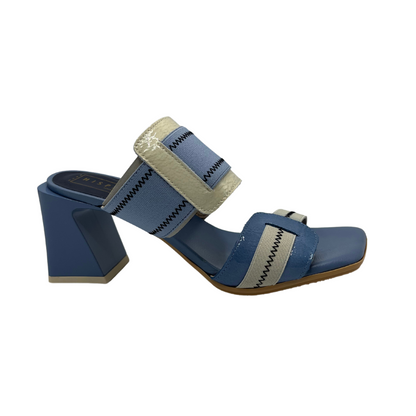 Right facing view of blue and natural leather and elastic slip on sandal. Featuring a square toe and unique block heel.