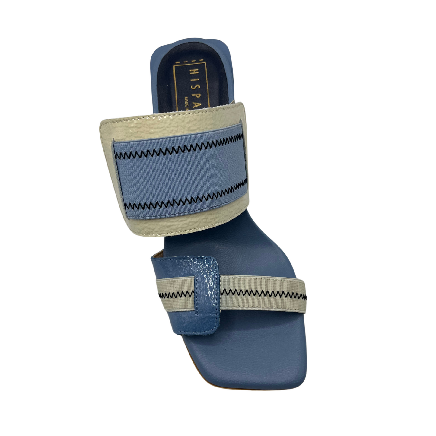 Top view of blue and natural leather and elastic slip on sandal. Featuring a square toe and unique block heel.