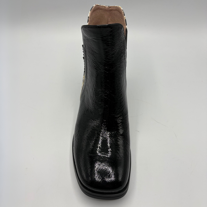 A single black leather ankle boot with a glossy finish, shown from a front-facing perspective on a light gray background.