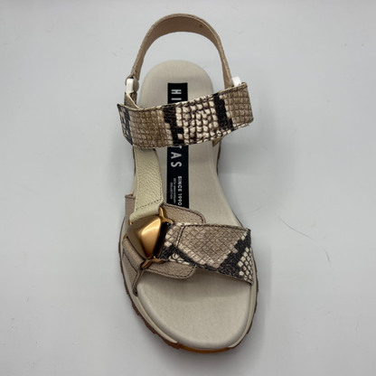 Beige sandal with gold bow and snake print strap on a white background