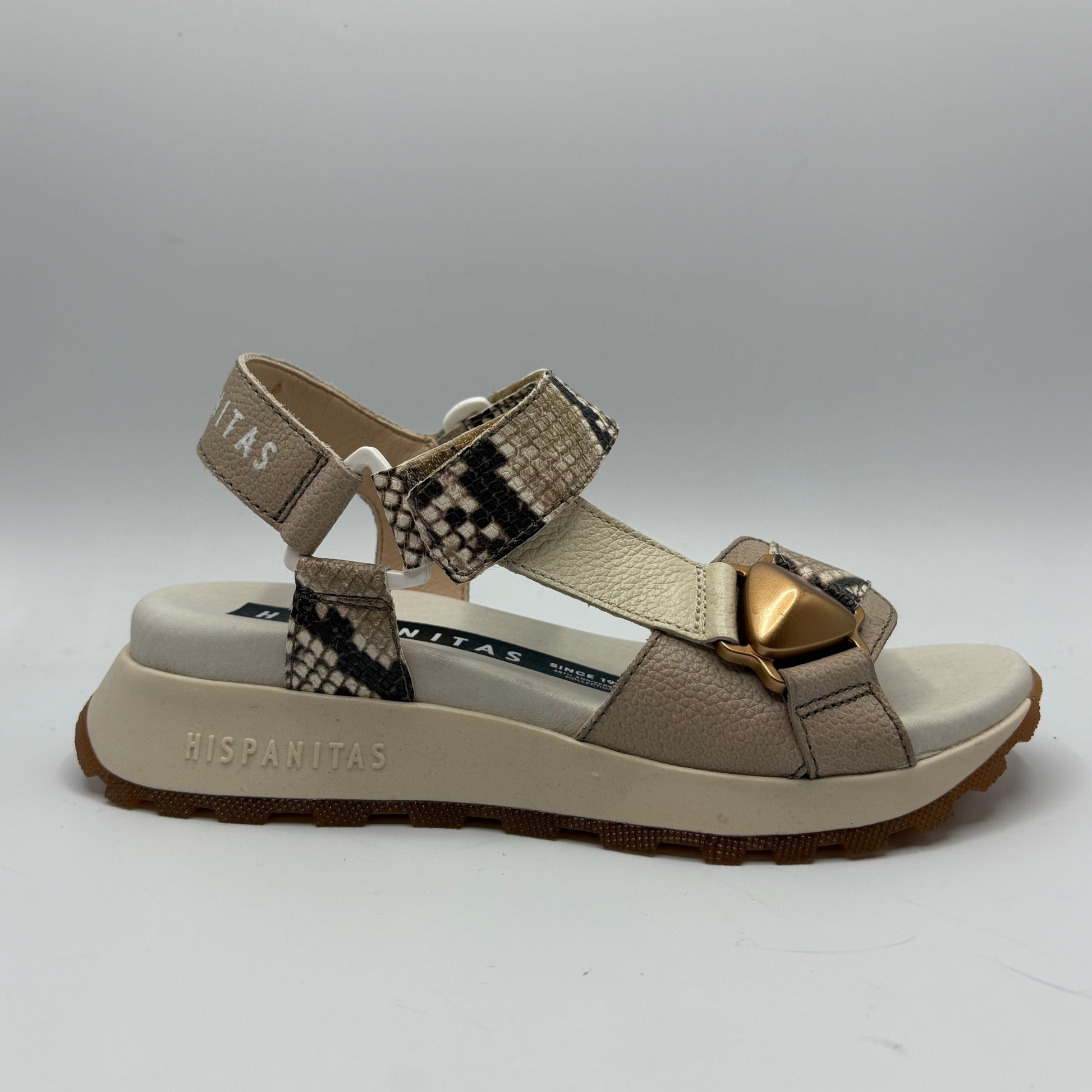 Beige sandal with snake print straps on a white background