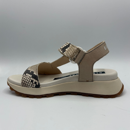 Beige sandal with patterned straps on a white background