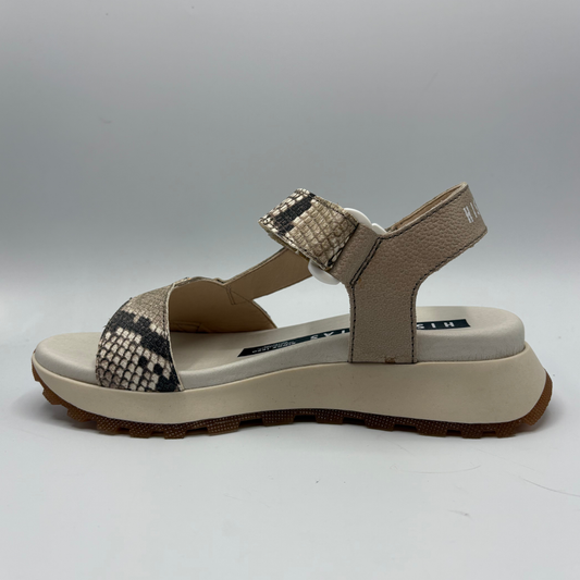 Beige sandal with patterned straps on a white background