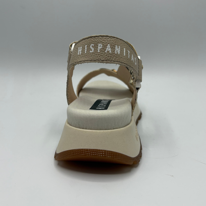Brown sandal with 'HISPANITAS' branding on a gray background