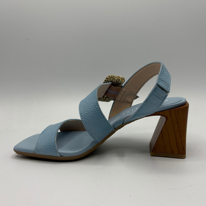 Blue sandal with a wooden heel on a gray background