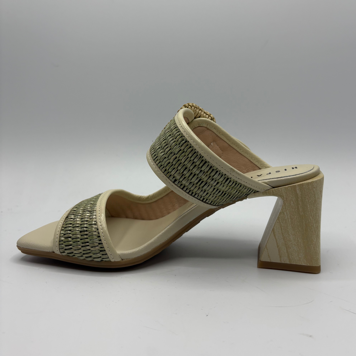 Beige sandal with woven strap and wooden heel on a gray background
