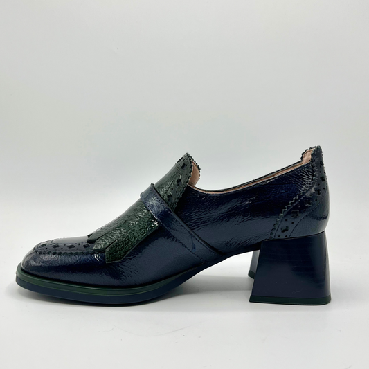 Navy blue shoe with green accents on a white background