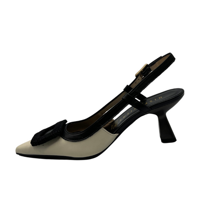 Left facing view of black and ivory leather pump with flared heel and slingback strap. 